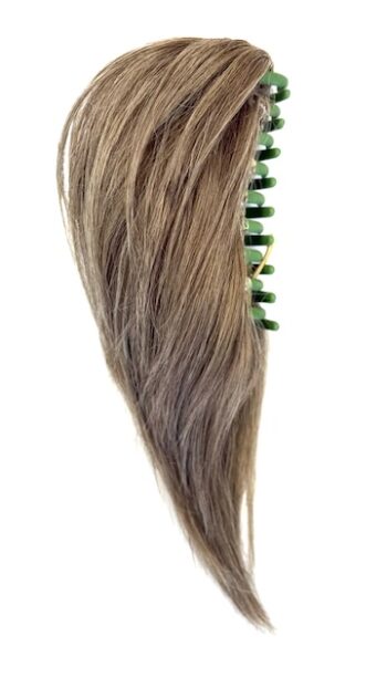 A long brown hair with green beads on top of it.