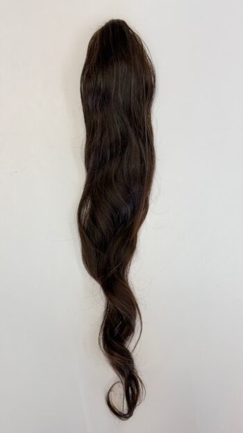 A long brown hair hanging on the wall