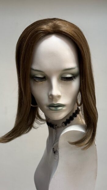 A mannequin with long hair and green eyes.