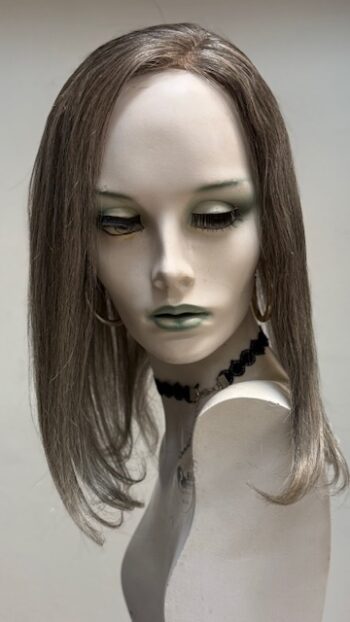 A mannequin with long hair and green eyes.