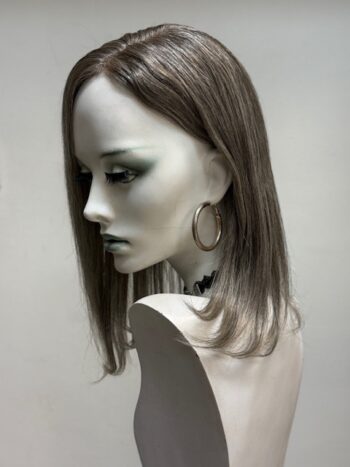 A mannequin with long hair and a large hoop earrings.