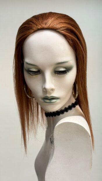 A mannequin with long red hair and green eyes.