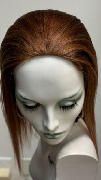 A mannequin with long red hair and green eyes.