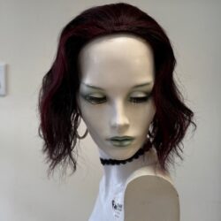 A mannequin with red hair and green eyes.