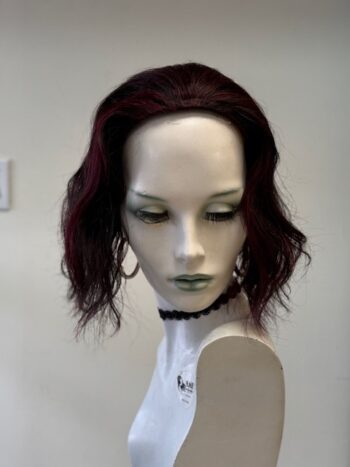 A mannequin with red hair and green eyes.