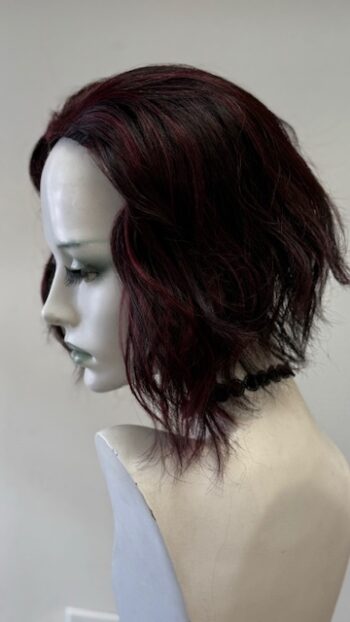 A mannequin head with a wig on it