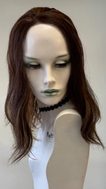 A mannequin with long brown hair and green eyes.