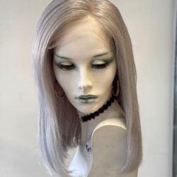 A mannequin wearing a necklace and a white wig.