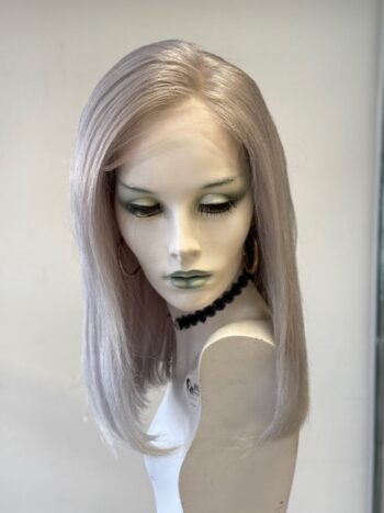 A mannequin wearing a necklace and a white wig.