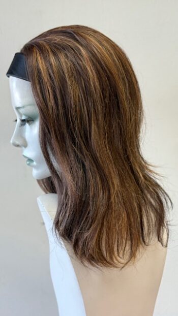 A mannequin head with long brown hair and a headband.