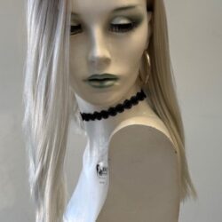 A mannequin wearing a white dress and black necklace.