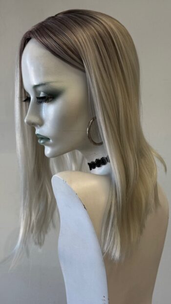 A mannequin with long blonde hair and black eye makeup.