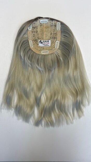 A blonde wig with long hair hanging on the back of it.