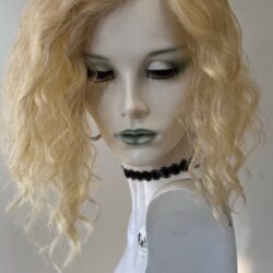 A mannequin with blonde hair and green eyes.