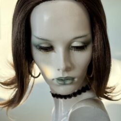 A mannequin with green eyes and black hair.