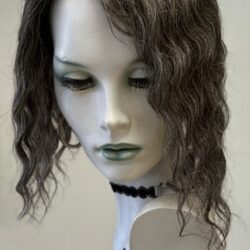 A mannequin head with long hair and green eyes.