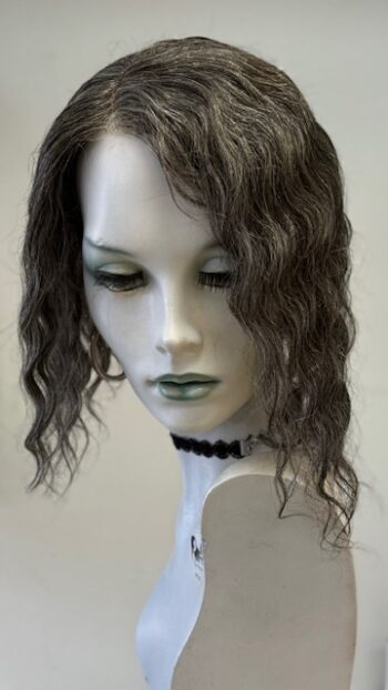 A mannequin head with long hair and green eyes.