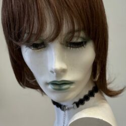 A mannequin with short hair and wearing a necklace.