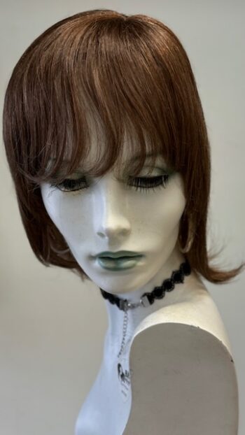 A mannequin with short hair and wearing a necklace.