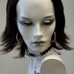 A mannequin with short hair and green eyes.