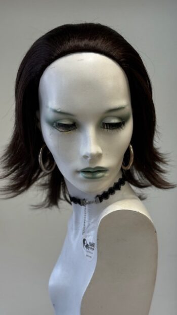 A mannequin with short hair and green eyes.