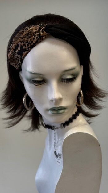 A mannequin with a headband and earrings.