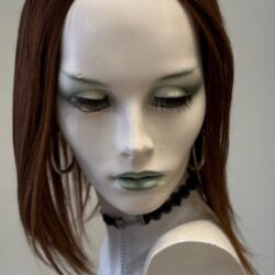 A mannequin with long hair and green eyes.