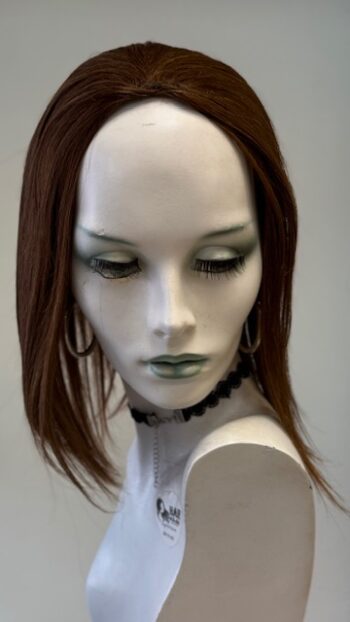 A mannequin with long hair and green eyes.