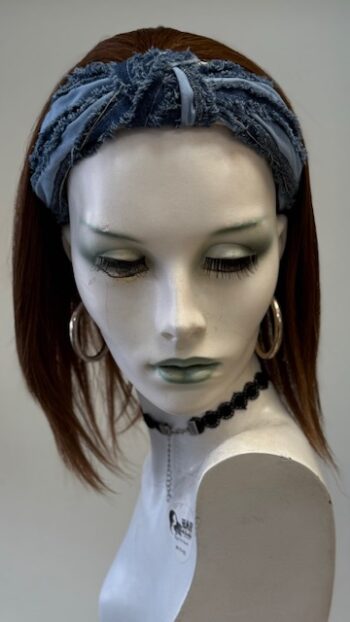 A mannequin wearing earrings and a headband.