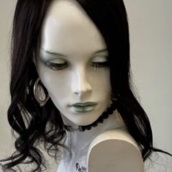 A mannequin with long black hair and white shirt.