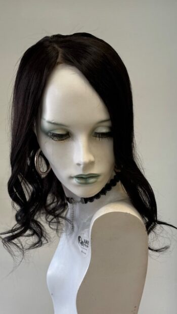 A mannequin with long black hair and white shirt.