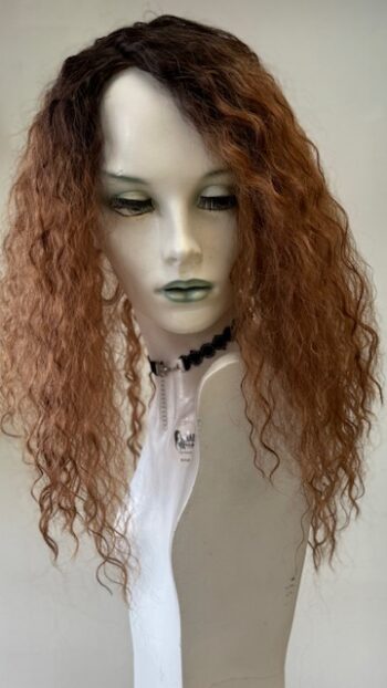 A mannequin with long curly hair and a white shirt.