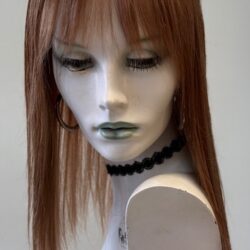 A mannequin with long red hair and green eyes.