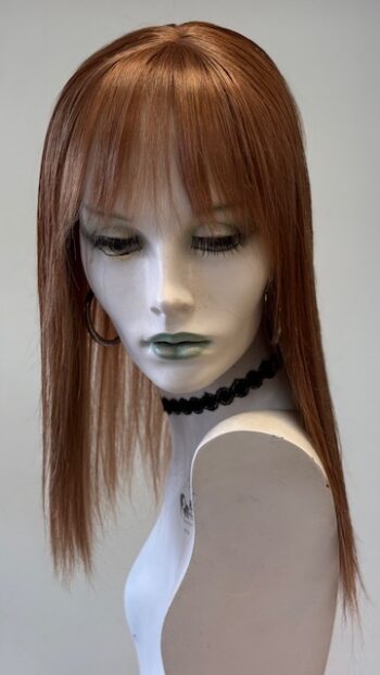 A mannequin with long red hair and green eyes.