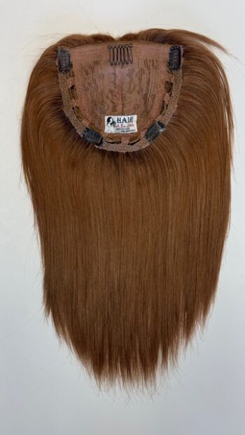 A brown wig hanging on the wall