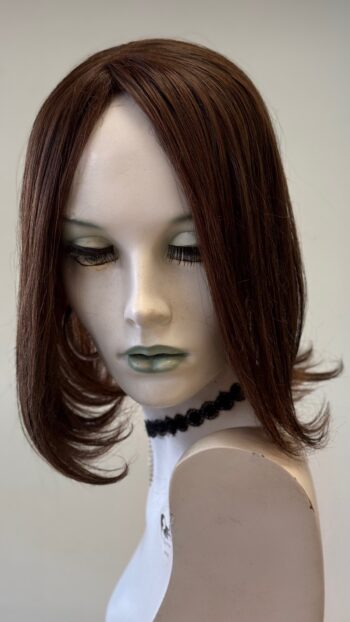 A mannequin head with a wig on it