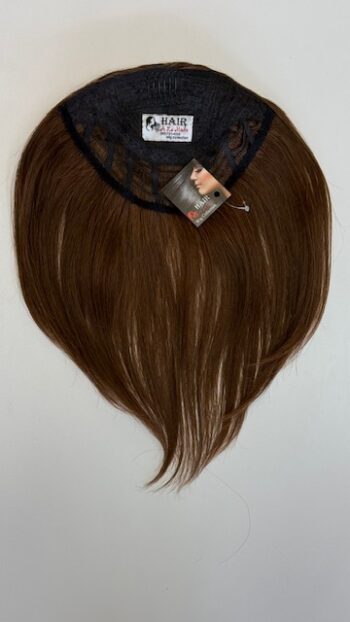 A brown wig with long hair hanging on the wall.