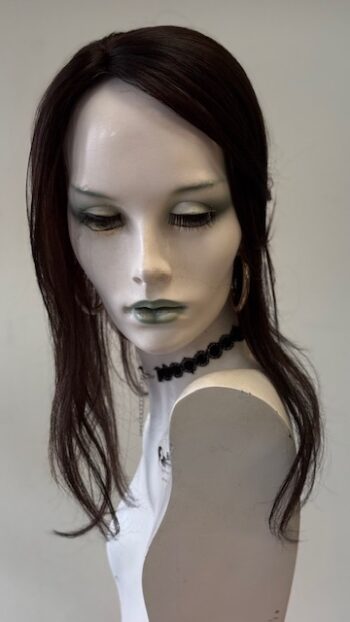 A mannequin with long black hair and green eyes.