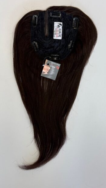 A brown wig hanging on the wall