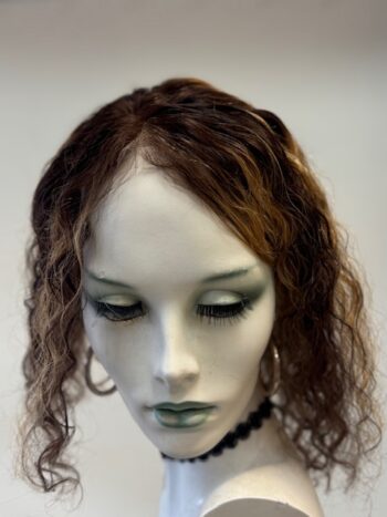 A mannequin with long hair and green eyes.