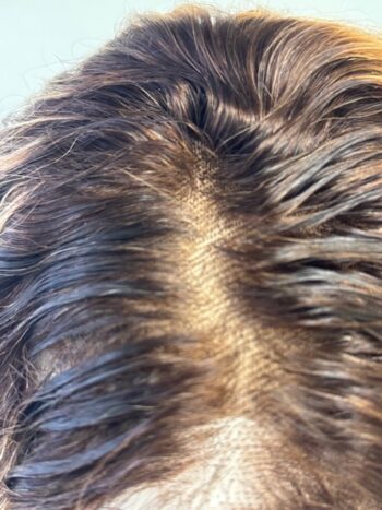 A close up of the back end of a dog 's hair.