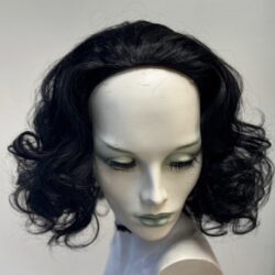 A mannequin head with black hair and green eyes.